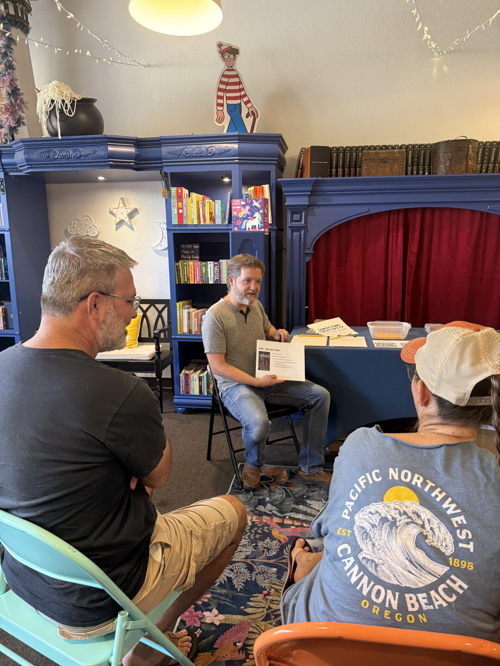 Josh Weiss-Roessler holds a page from his Gamifying Creativity workshop as he talks to his audience.
